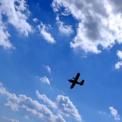 Low angle view of airplane flying in sky