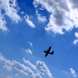 Low angle view of airplane flying in sky