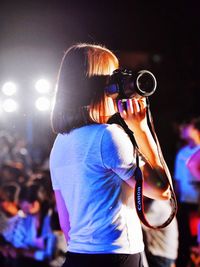 Rear view of woman photographing