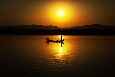 Silhouette of boat at sunset