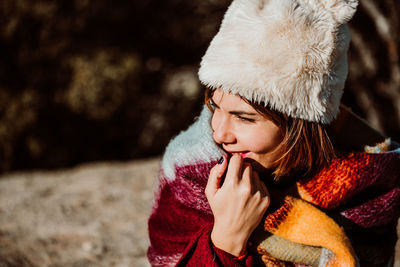 Portrait of young woman looking away during winter