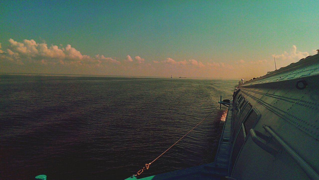 sea, sky, horizon over water, water, sunset, cloud - sky, scenics, transportation, beauty in nature, nature, tranquility, tranquil scene, high angle view, idyllic, outdoors, cloud, railing, mode of transport, cloudy, beach