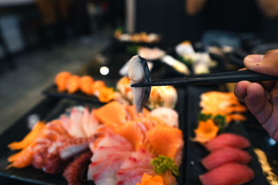 Cropped image of person preparing food on barbecue grill