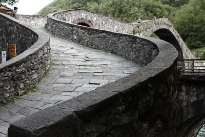 Arch bridge over stone wall