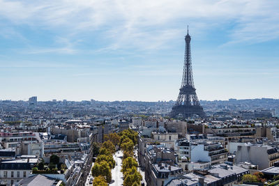 Eiffel tower in city against sky