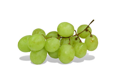 Close-up of grapes over white background