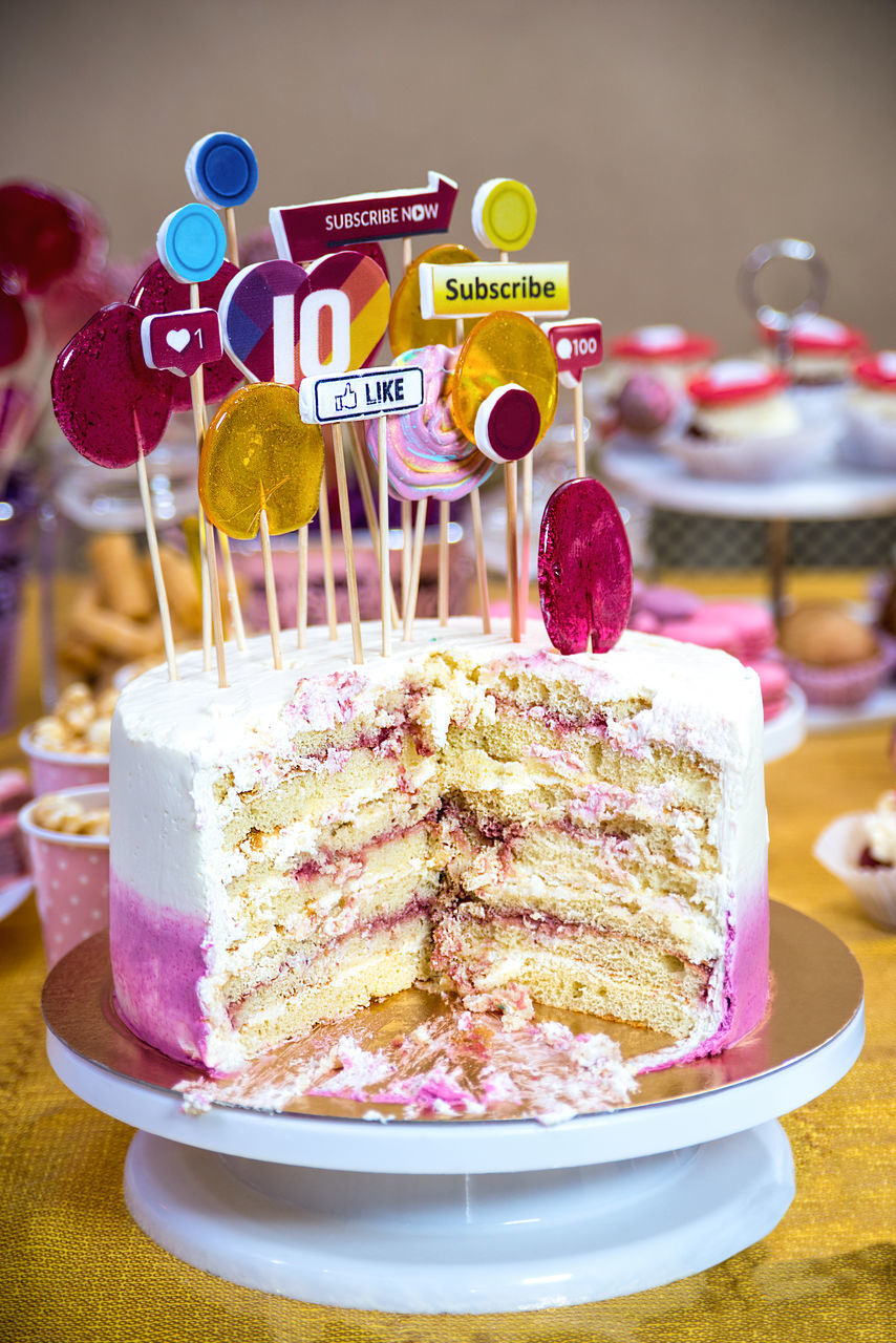 CLOSE-UP OF CAKE WITH ICE CREAM WITH SPOON ON TABLE