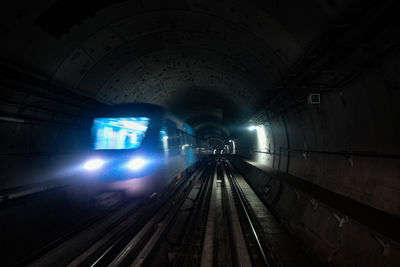 Train in illuminated tunnel