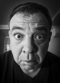 Astonished adult male close-up face, black and white portrait