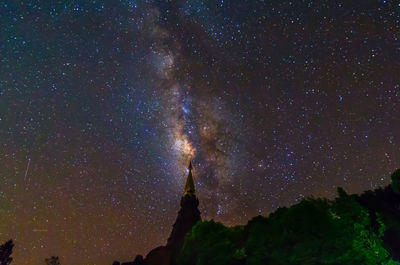 Low angle view of silhouette stars against sky at night