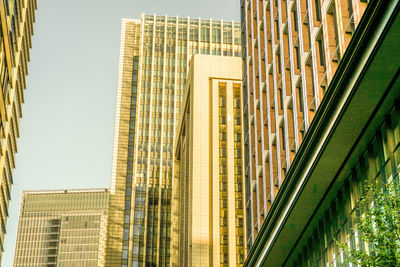 Low angle view of modern buildings against clear sky