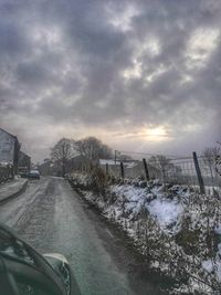 Car on road against sky during winter