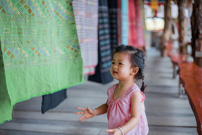 Girl standing by clothesline