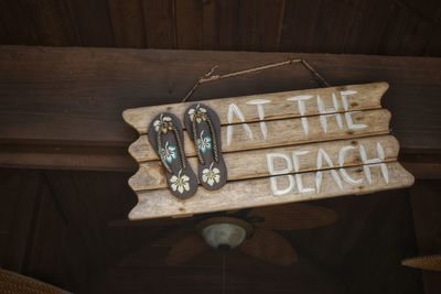 Close-up of wooden signboard with text