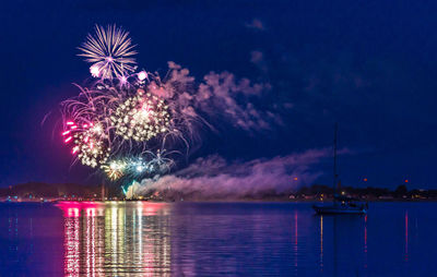 Low angle view of firework display at night