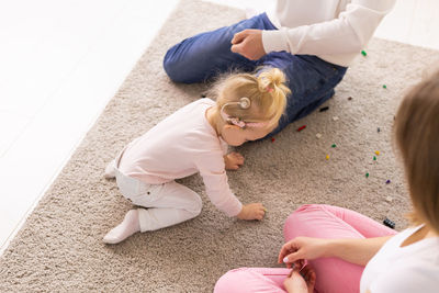 High angle view of mother and daughter at home