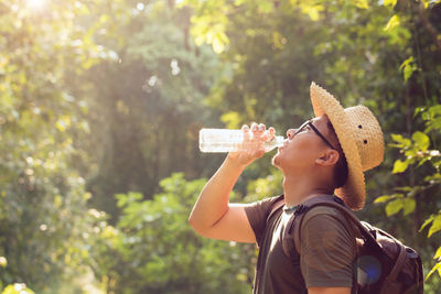 Portrait of man wearing hat drinking glass