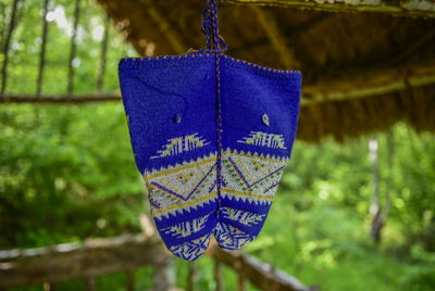 Close-up of ropes hanging on rope against trees