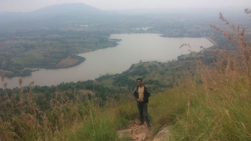 Man standing on mountain against sky