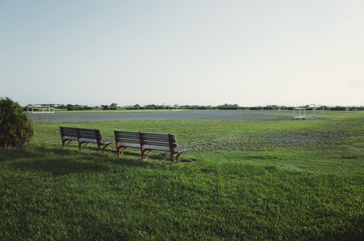 field, grass, land, plant, sky, landscape, tranquility, tranquil scene, environment, nature, copy space, scenics - nature, green color, clear sky, beauty in nature, bench, day, growth, seat, no people, outdoors, park bench