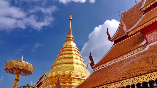 Low angle view of pagoda and temple building against sky