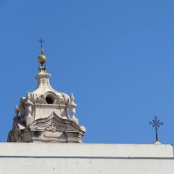 Low angle view of cross against clear blue sky