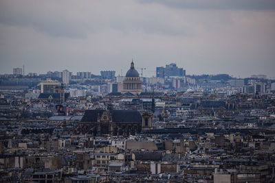 The view on the parisian rooftops from montmartre on a gloomy day, or, the french capital cityscape.