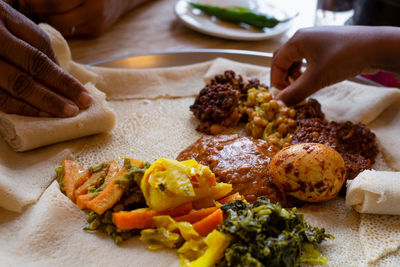 Cropped hands of person preparing food