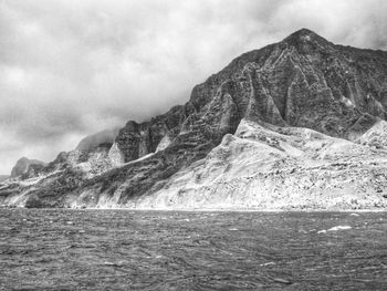 Scenic view of sea and mountains against sky