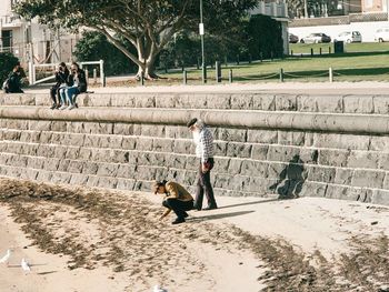 People playing with dog