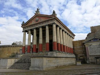 Low angle view of historical building against cloudy sky