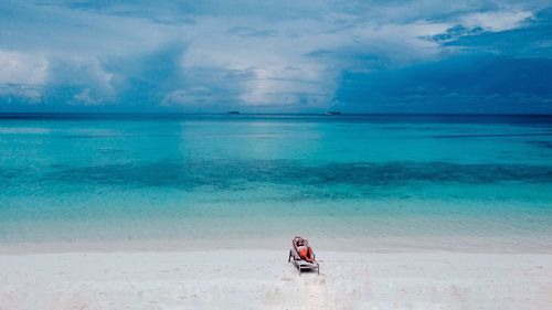 People on beach against sky
