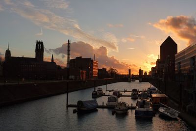 Boats in river at sunset