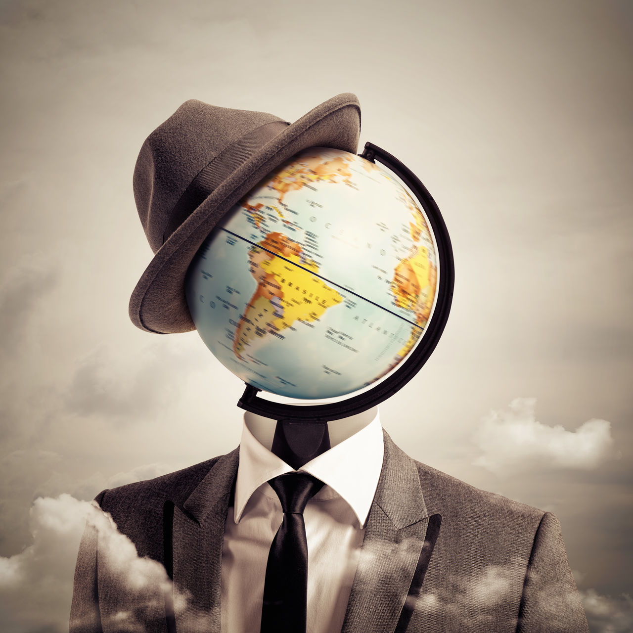 CLOSE-UP PORTRAIT OF A MAN HOLDING UMBRELLA AGAINST SKY