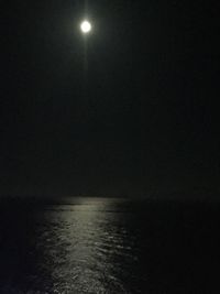 Scenic view of sea against clear sky at night