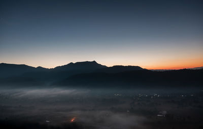 Scenic view of silhouette mountains against sky during sunset