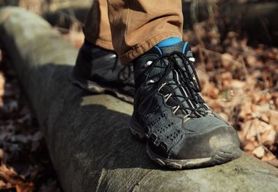 Low section of man walking on pipe