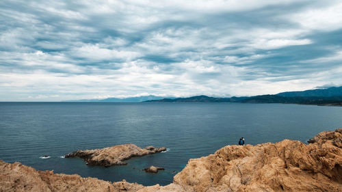 Scenic view of sea and rocks against sky