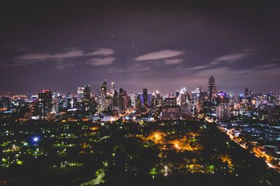 Illuminated cityscape against sky at night