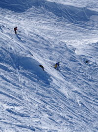Tourists skiing in snow