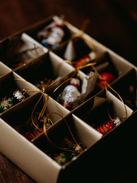 High angle view of christmas ornaments in box on table