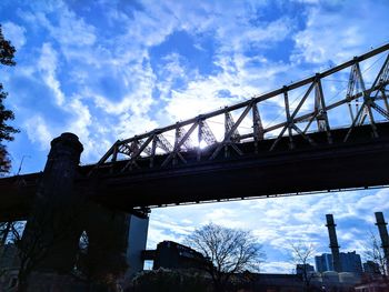 Low angle view of bridge against sky in city