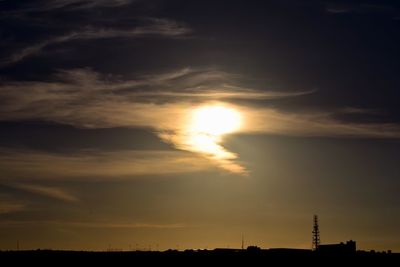 Silhouette of building against cloudy sky