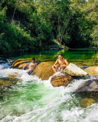 Scenic view of river flowing amidst trees in forest