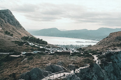 Scenic view of sea and mountains against sky