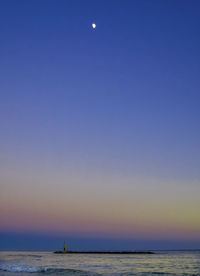 Scenic view of sea against clear sky during sunset