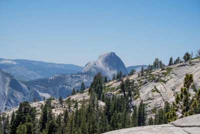 Scenic view of snowcapped mountains against clear blue sky