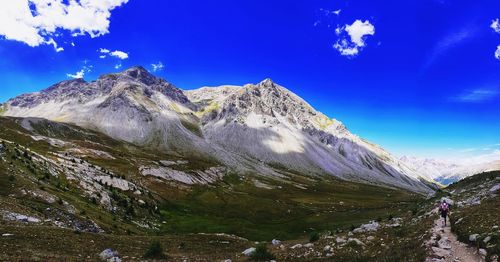 Scenic view of snowcapped mountains against blue sky