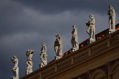 Low angle view of statues against sky