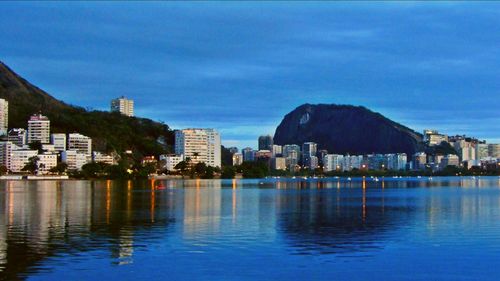 Calm sea with buildings in background